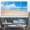 Designart - Large Clouds Over Calm Beach - Seashore Photo Canvas Print